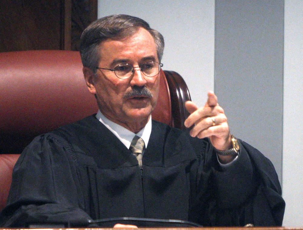 FILE - In this Nov. 9, 2010 file photo, Oklahoma County District Judge Ray Elliott gestures as he presides over court in Oklahoma City. Judge Elliott has agreed to convene a grand jury to investigate the state's Pardon and Parole Board and conditions at the Oklahoma County jail. The Oklahoman reports presiding Judge Ray Elliott agreed Wednesday, Sept. 29, 2021, to the request by District Attorney David Prater. (AP Photo/Sue Ogrocki File)