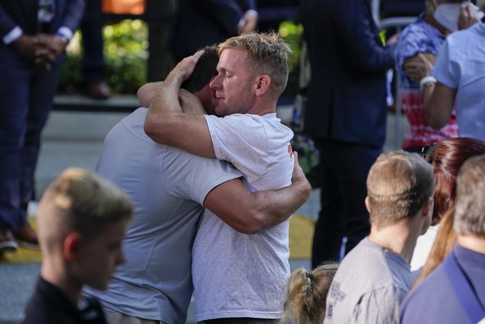 People react as they attend a ceremony marking the 20th anniversary of the Sept. 11, 2001, terrorist attacks at the National September 11 Memorial and Museum in New York, Saturday, Sept. 11, 2021. (AP Photo/Evan Vucci)