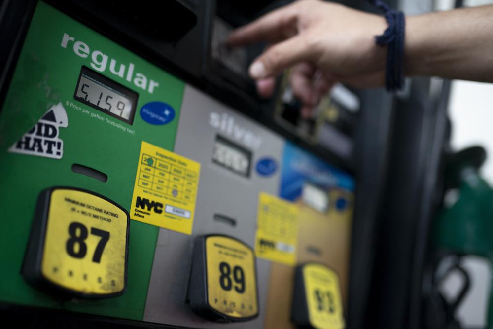 FILE - Wallace Reid purchases fuel for the vehicle he drives to make a living using ride-share apps, Wednesday, June 22, 2022, in the Queens borough of New York. (AP Photo/John Minchillo, File)