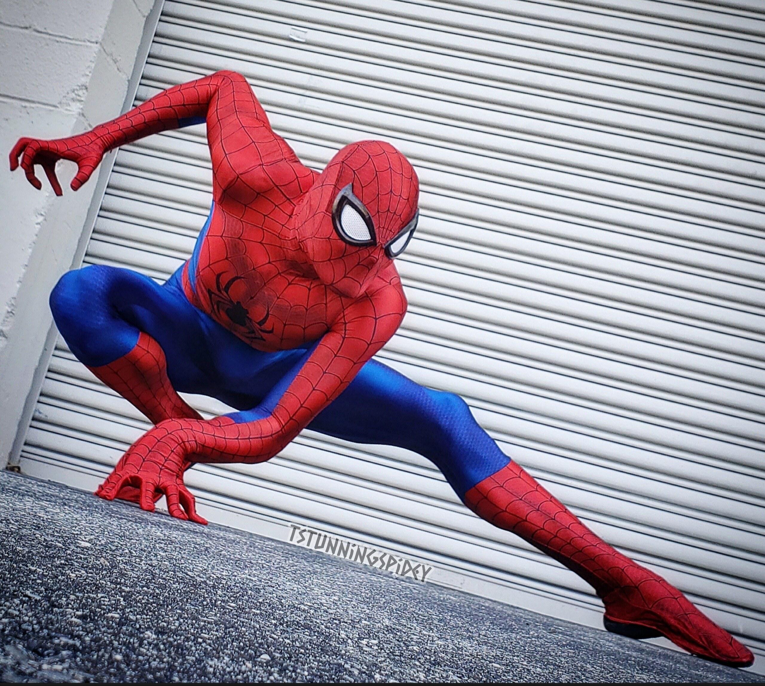 Cosplayer in image of a character Spider-Man with his beloved girlfriend sit  on roof against cityscape and night lights Stock Photo - Alamy