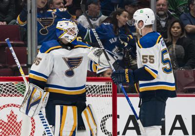 St. Louis Blues' goalie Ville Husso (35) is celebrates with Colton Parayko after the Blues defeated the Vancouver Canucks 4-3 in an NHL hockey game Wednesday, March 30, 2022, in Vancouver, British Columbia. (Rich Lam/The Canadian Press via AP)