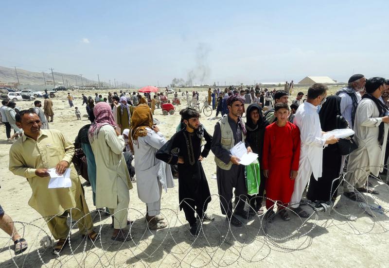 Hundreds of people gather outside the international airport in Kabul, Afghanistan, Tuesday, Aug. 17, 2021. The Taliban declared an “amnesty” across Afghanistan and urged women to join their government Tuesday, seeking to convince a wary population that they have changed a day after deadly chaos gripped the main airport as desperate crowds tried to flee the country. (AP Photo)