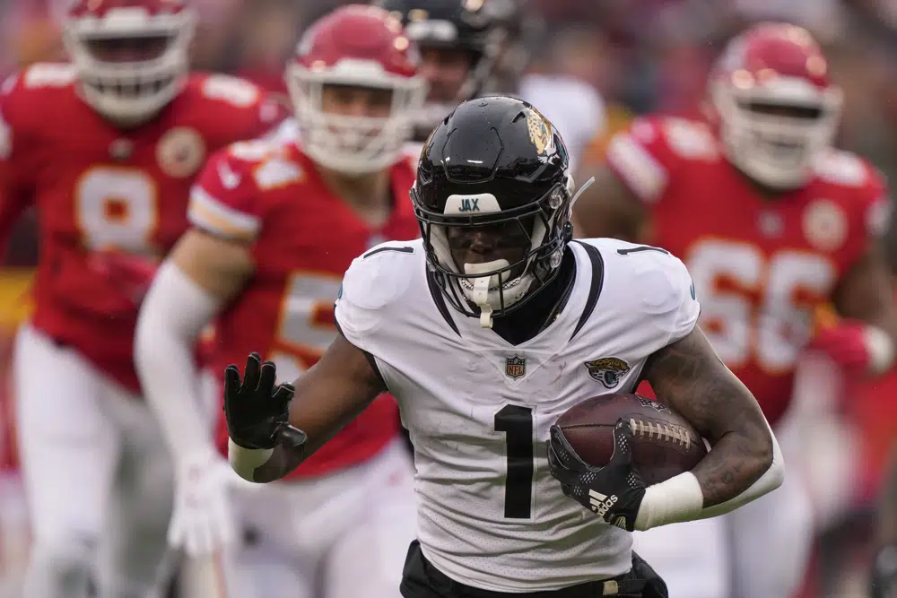 Jacksonville Jaguars running back Travis Etienne Jr. (1) runs against the Kansas City Chiefs during the first half of an NFL divisional round playoff football game, Saturday, Jan. 21, 2023, in Kansas City, Mo. (AP Photo/Charlie Riedel)