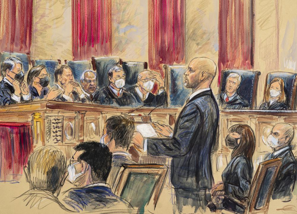 FILE - This artist sketch depicts lawyer Scott Keller standing to argue on behalf of more than two dozen business groups seeking an immediate order from the Supreme Court to halt a Biden administration order to impose a vaccine-or-testing requirement on the nation's large employers during the COVID-19 pandemic, at the Supreme Court in Washington, Jan. 7, 2022. The Supreme Court has stopped the Biden administration from enforcing a requirement that employees at large businesses be vaccinated against COVID-19 or undergo weekly testing and wear a mask on the job. The court's order Thursday during a spike in coronavirus cases deals a blow to the administration's efforts to boost the vaccination rate among Americans. (Dana Verkouteren via AP, File)