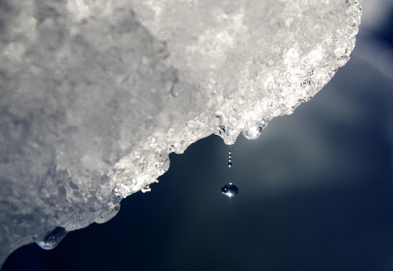 FILE - A drop of water falls off an iceberg melting in the Nuup Kangerlua Fjord near Nuuk in southwestern Greenland, Tuesday, Aug. 1, 2017. Earth’s poles are undergoing simultaneous freakish extreme heat with parts of Antarctica more than 70 degrees (40 degrees Celsius) warmer than average and areas of the Arctic more than 50 degrees (30 degrees Celsius) warmer than average. (AP Photo/David Goldman, File)