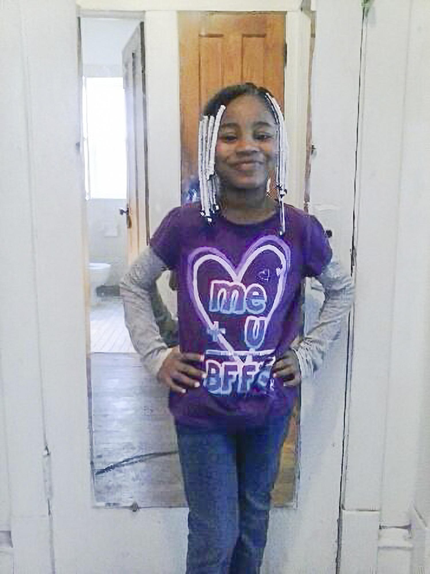 In this undated photo provided by her family, Amaria Jones stands for a photo wearing her favorite color, purple. Gun violence is killing an increasing number of American children, many of them caught in crossfire. When a stray bullet pierced the window of a Chicago home in 2020, it hit and killed 13-year-old Amaria as she danced for her mother. (Jones Family via AP)