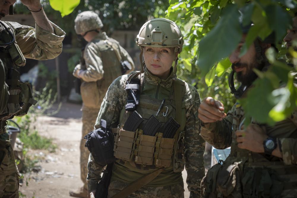 Ukrainian platoon commander Mariia talks to her soldiers in their position in the Donetsk region, Ukraine, Saturday, July 2, 2022. Ukrainian soldiers returning from the frontlines in eastern Ukraine’s Donbas region describe life during what has turned into a grueling war of attrition as apocalyptic. Mariia, 41, said that front-line conditions may vary depending on where a unit is positioned and how well supplied they are. (AP Photo/Efrem Lukatsky)
