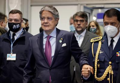 El presidente ecuatoriano Guillermo Lasso, centro, recorre un pasillo dentro de la sede de la cumbre climática de la ONU COP26, Glasgow, Escocia, 2 de noviembre de 2021. Lasso también visitó España.  (AP Foto / Alberto Pezzali)