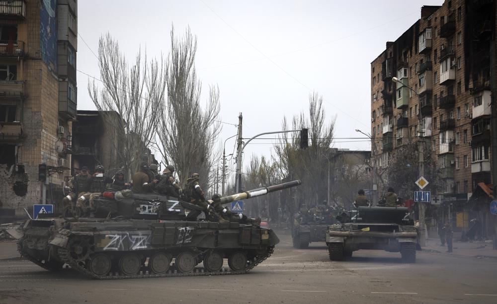 Russian military vehicles move in an area controlled by Russian-backed separatist forces in Mariupol, Ukraine, Saturday, April 23, 2022. (AP Photo/Alexei Alexandrov)