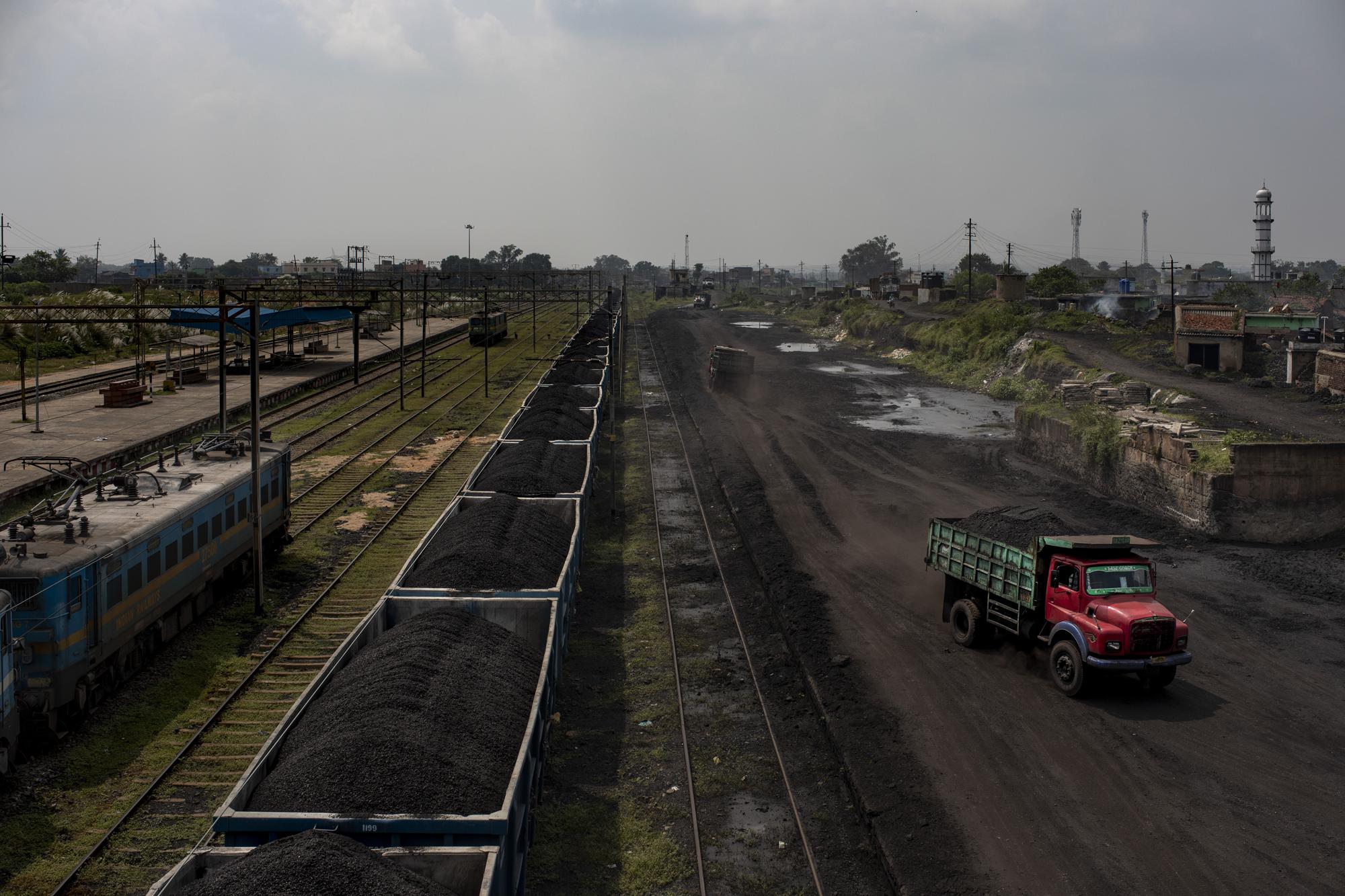 A truck loaded with coal drives past a stationary freight train carrying coal at Chainpur village near Hazaribagh, in eastern state of Jharkhand, Sunday, Sept. 26, 2021. A 2021 Indian government study found that Jharkhand state -- among the poorest in India and the state with the nation’s largest coal reserves -- is also the most vulnerable Indian state to climate change. Efforts to fight climate change are being held back in part because coal, the biggest single source of climate-changing gases, provides cheap electricity and supports millions of jobs. It's one of the dilemmas facing world leaders gathered in Glasgow, Scotland this week in an attempt to stave off the worst effects of climate change. (AP Photo/Altaf Qadri)