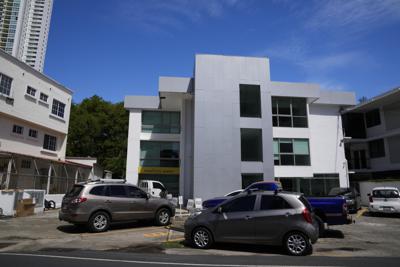 Automóviles estacionados en el edificio Coco del Mar Suites, donde según investigadores se aplicaron clandestinamente supuestas vacunas para el COVID-19 de Pfizer, en el exclusivo barrio Coco del Mar en la ciudad de Panamá, el jueves 10 de junio de 2021. (AP Foto/Arnulfo Franco)