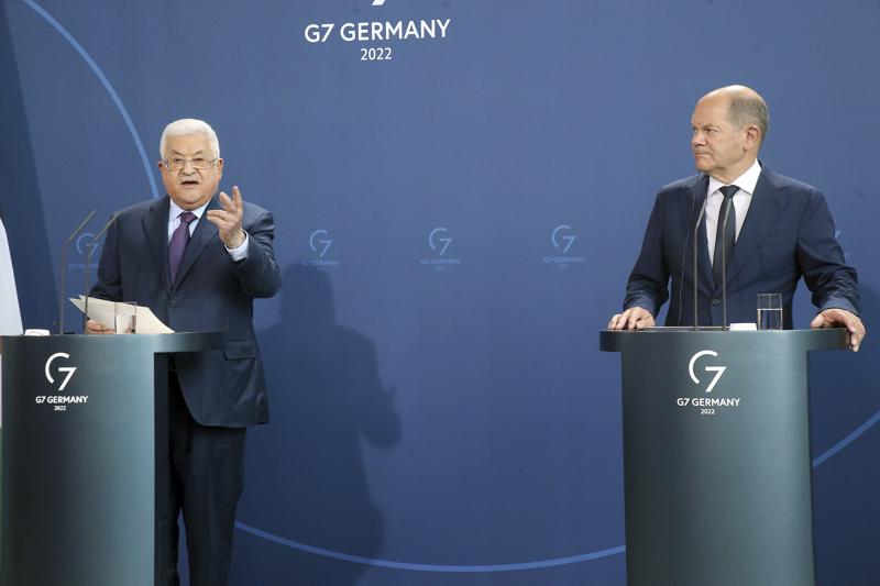 Palestinian President Mahmoud Abbas, left, speaks during a news conference after a meeting with German Chancellor Olaf Scholz, right, at the Chancellery in Berlin, Tuesday, Aug. 16, 2022. German Chancellor Olaf Scholz said on Wednesday, Aug. 17, 2022, that “For us Germans in particular, any relativization of the singularity of the Holocaust is intolerable and unacceptable. I condemn any attempt to deny the crimes of the Holocaust.” ( Wolfgang Kumm/dpa via AP)