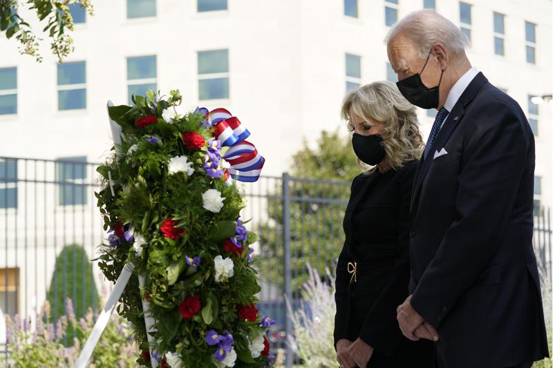 President Joe Biden and first lady Jill Biden participate in a wreath ceremony on the 20th anniversary of the terrorist attacks at the Pentagon in Washington, Saturday, Sept. 11, 2021, standing at the National 9/11 Pentagon Memorial site, which commemorates the lives lost at the Pentagon and onboard American Airlines Flight 77. With the President, not shown, are Vice President Kamala Harris and her husband Douglas Emhoff, Secretary of Defense Lloyd Austin and Joint Chiefs Chairman Gen. Mark Milley and his wife Hollyanne Milley. (AP Photo/Alex Brandon)