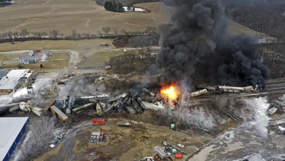 This photo taken with a drone shows portions of a Norfolk and Southern freight train that derailed Friday night in East Palestine, Ohio are still on fire at mid-day Saturday, Feb. 4, 2023. (AP Photo/Gene J. Puskar)