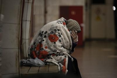 An elderly woman sits on a bench wrapped in a blanket in a subway station turned into a shelter in Kyiv, Ukraine, Tuesday, March 8, 2022. Demands for ways to safety evacuate civilians have surged along with intensifying shelling by Russian forces, who have made significant advances in southern Ukraine but stalled in some other regions. Efforts to put in place cease-fires along humanitarian corridors have repeatedly failed amid Russian shelling. (AP Photo/Vadim Ghirda)