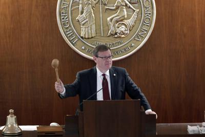 FILE - House Speaker Tim Moore, R-Cleveland, gavels in a session as North Carolina legislators convene on the House floor to move forward a coronavirus relief package in Raleigh, N.C., April 30, 2020. The North Carolina Senate on Wednesday, Aug. 25, 2021, approved a bill to raise penalties on those who engage in violent protests. The proposal from Moore comes as a response to rioting and looting he saw take place in Raleigh last year amid frustration over the murder of George Floyd in Minneapolis police custody. (AP Photo/Gerry Broome, File)