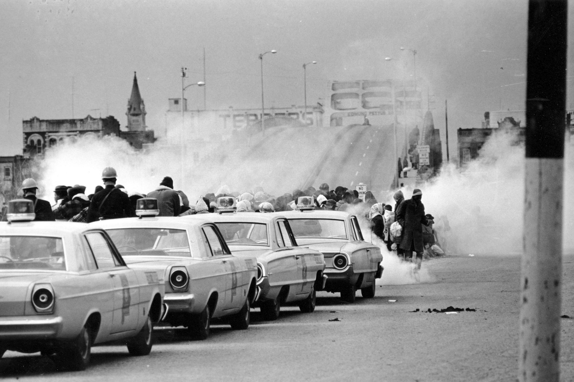 FILE - Tear gas fumes fill the air as state troopers, ordered by Gov. George Wallace, break up a demonstration march in Selma, Ala., on what is known as Bloody Sunday on March 7, 1965. Andrew Young, one of the last surviving members of Martin Luther King Jr.'s inner circle, recalled the journey to the signing of the Voting Rights Act as an arduous one, often marked by violence and bloodshed. (AP Photo)