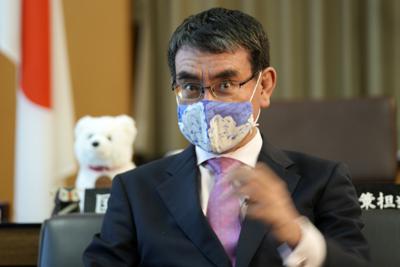 AP Interview: Japan minister urges young adults to get shots