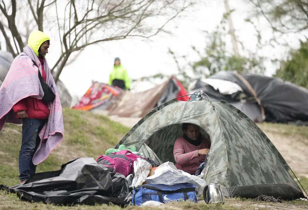 FILE - Migrants from Venezuela prepare for relocation to a refugee shelter in Matamoros, Mexico, Dec. 23, 2022. The Supreme Court is keeping pandemic-era limits on people seeking asylum in place indefinitely, dashing hopes of immigration advocates who had been anticipating their end this week. The restrictions, often referred to as Title 42, were put in place under then-President Donald Trump at the beginning of the pandemic to curb the spread of COVID-19. (AP Photo/Fernando Llano, File)