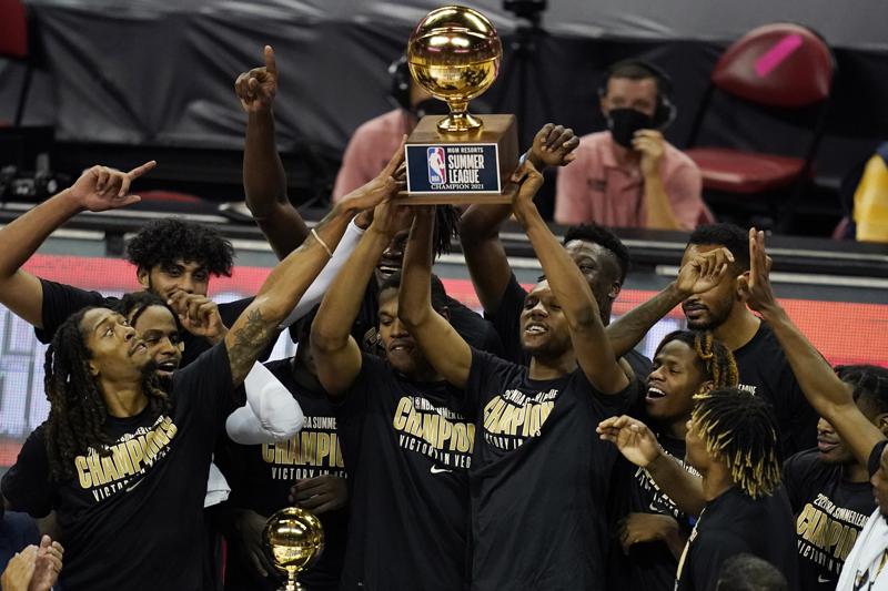 Sacramento Kings players hold up the trophy after defeating the Boston Celtics in the NBA summer league championship basketball game Tuesday, Aug. 17, 2021, in Las Vegas. (AP Photo/John Locher)