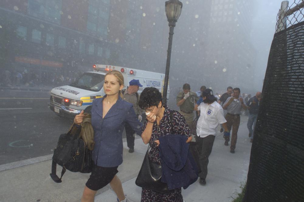 FILE - People flee from downtown Manhattan after planes crashed into the twin towers of the World Trade Center on September 11, 2001 in New York City. Associated Press photographer Richard Drew talks about AP’s coverage of 9/11 and the events that followed. (AP Photo/Richard Drew)
