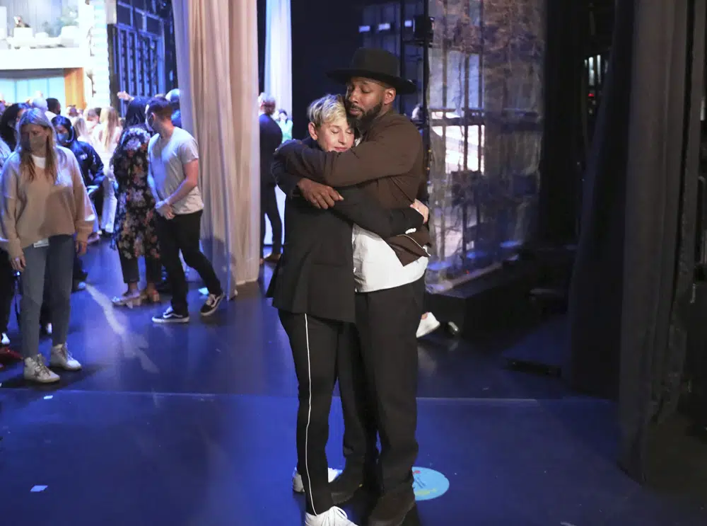 FILE - In this photo released by Warner Bros., talk show host Ellen DeGeneres embraces Stephen "tWitch" Boss during a taping of "The Ellen DeGeneres Show" at the Warner Bros. lot in Burbank, Calif. Boss, a longtime DJ and co-executive producer on the talk show “The Ellen DeGeneres Show” and former contestant on the dance competition show, “So You Can Think You Can Dance” has died at the age of 40. (Photo by Michael Rozman/Warner Bros., File)