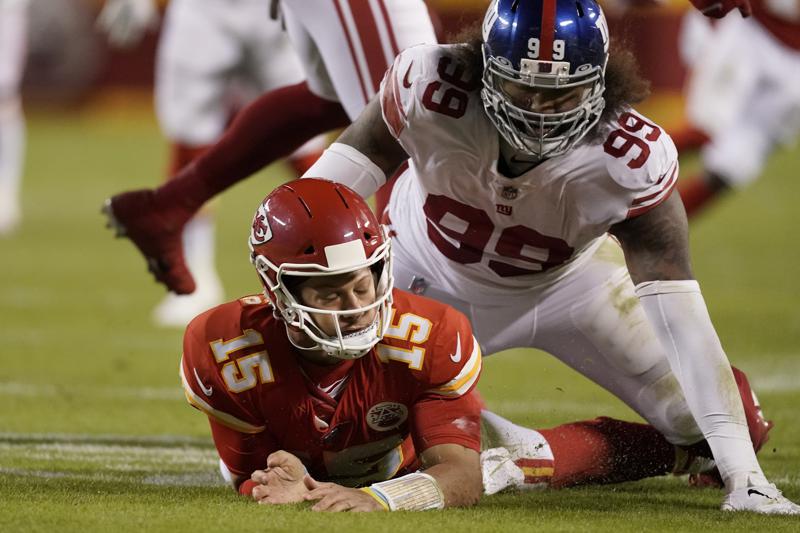 Kansas City Chiefs quarterback Patrick Mahomes (15) is slow to get up after throwing under pressure from New York Giants defensive end Leonard Williams (99) during the first half of an NFL football game Monday, Nov. 1, 2021, in Kansas City, Mo. (AP Photo/Charlie Riedel)