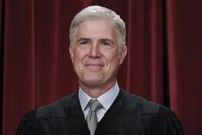 ARCHIVO - El juez asociado Neil Gorsuch se une a otros miembros de la Corte Suprema mientras posan para un nuevo retrato de grupo, en el edificio de la Corte Suprema en Washington, el viernes, octubre. 7, 2022. Gorsuch llamó a las medidas de emergencia tomadas durante la crisis de la COVID-19 que mató a más de 1 millón de estadounidenses, tal vez "las mayores intrusiones en las libertades civiles en la historia de este país en tiempo de paz". La justicia conservadora de 55 años señaló las órdenes de cerrar las escuelas, restringir los servicios de la iglesia, ordenar las vacunas y prohibir los desalojos en un lado amplio dirigido a los funcionarios locales, estatales y federales, incluso a sus colegas. (AP Photo/J. Scott Applewhite, Archivo)