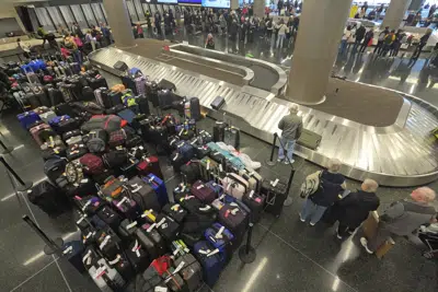 Baggage waits to be claimed at the Southwest Airlines baggage claim Tuesday, Dec. 27, 2022, at Salt Lake City International Airport, in Salt Lake City. Many airlines were forced to cancel flights due to the weather, but Southwest was by far the most affected. Of the 2,890 flight cancellations in the U.S. early Tuesday, 2,522 were called off by Southwest, according to the tracking website FlightAware. (AP Photo/Rick Bowmer)