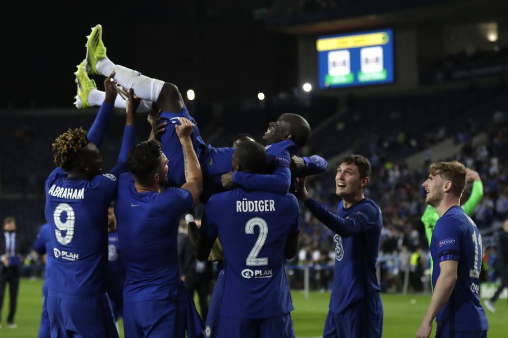 Chelsea players throw Chelsea's N'Golo Kante into the air as they celebrate winning the Champions League final soccer match between Manchester City and Chelsea at the Dragao Stadium in Porto, Portugal, Saturday, May 29, 2021. (AP Photo/Manu Fernandez, Pool)