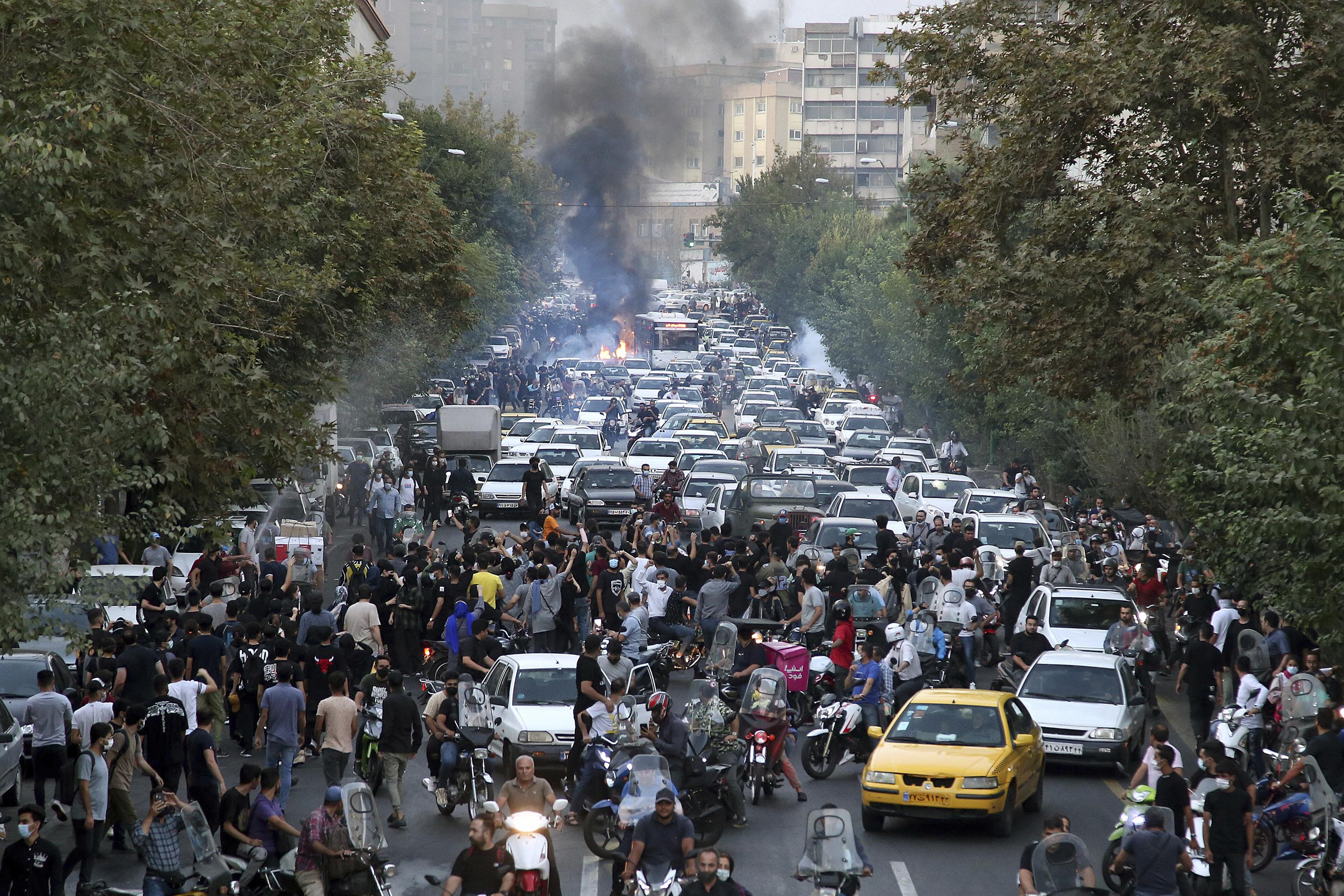 At least 9 killed as Iran protests spread over woman's death - The Associated Press