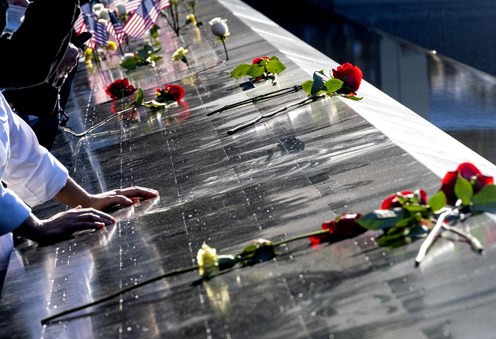 Flowers adorn the names of people who were killed during the attacks on the World Trade Center on Sept. 11, 2001, as families gather at the National September 11 Memorial in New York on the 20th anniversary of the attacks, Saturday, Sept. 11, 2021. (Craig Ruttle/Newsday via AP, Pool)