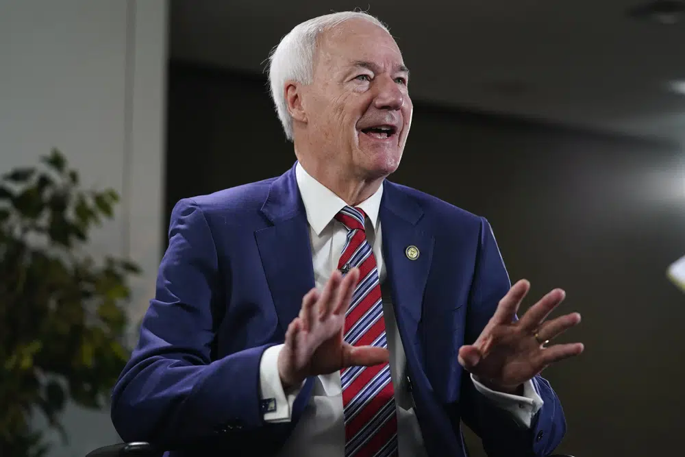 Arkansas Governor Asa Hutchinson gestures during an interview with the Associated Press, Tuesday, Dec. 13, 2022 in Washington. (AP Photo/Pablo Martinez Monsivais)