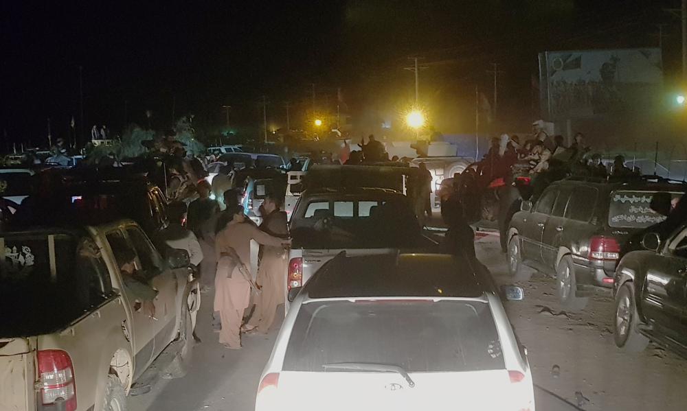 Afghan military and officials leave Kandahar city during fighting between the Taliban and Afghan security personnel, in Kandahar, southwest of Kabul, Afghanistan, Thursday, Aug. 12, 2021. (AP Photo/Sidiqullah Khan)