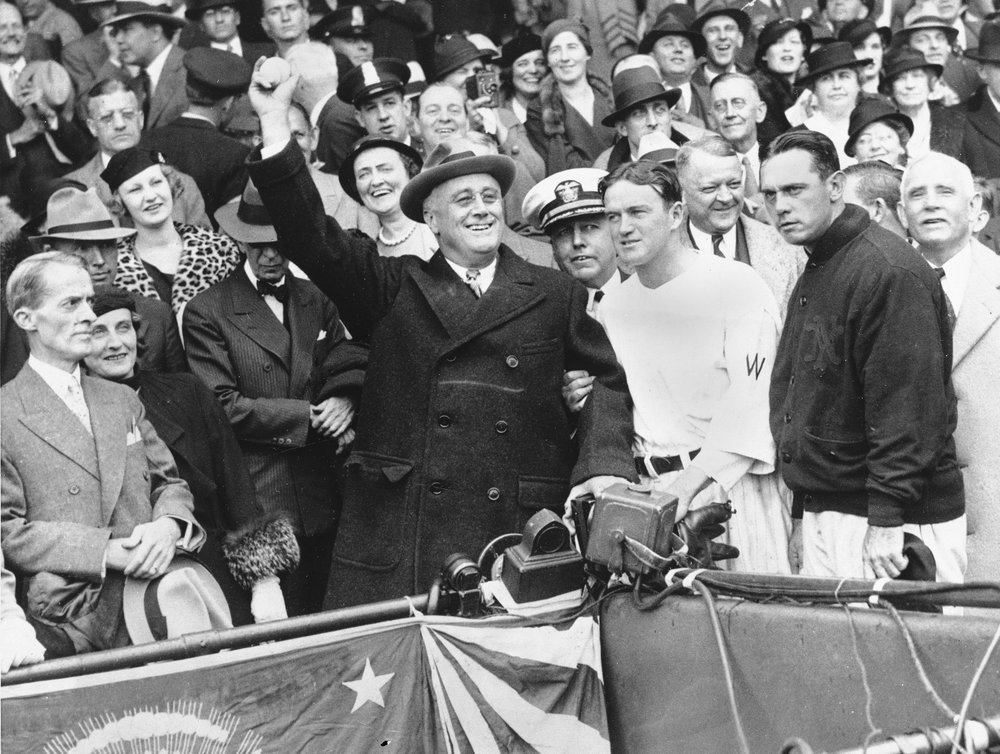 FILE - In this Oct. 5, 1933, file photo, President Franklin D. Roosevelt prepares to throw out the ceremonial first pitch at at Griffith Stadium in Washington, before Game 3 of baseball's World Series. The President uncorked an almost wild throw that sent the players scrambling. (AP Photo/File)