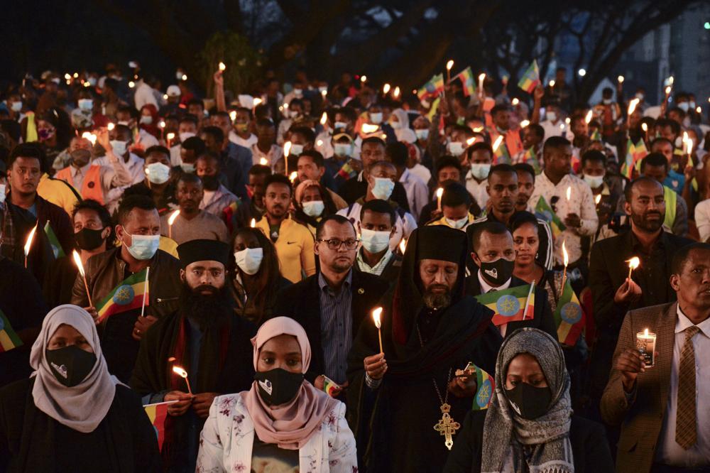 Members of the public join current and former Ethiopian military personnel to commemorate federal soldiers killed by forces loyal to the Tigray People's Liberation Front (TPLF) at the start of the conflict one year ago, at a candlelit event outside the city administration in Addis Ababa, Ethiopia Wednesday, Nov. 3, 2021. All sides in Ethiopia's yearlong war in the Tigray region have committed abuses marked by "extreme brutality" that could amount to war crimes and crimes against humanity, the U.N. human rights chief said Wednesday. (AP Photo)