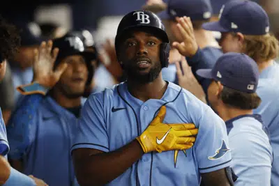 FILE - Tampa Bay Rays' Randy Arozarena reacts in the dugout after hitting a three-run home against the Toronto Blue Jays during the fifth inning of a baseball game Sept. 23, 2022, in St. Petersburg, Fla. In a decision announced Saturday, Dec. 24, 2022, the United States will permit Major League Baseball players from Cuba to represent their home country in the World Baseball Classic next year. (AP Photo/Scott Audette, File)