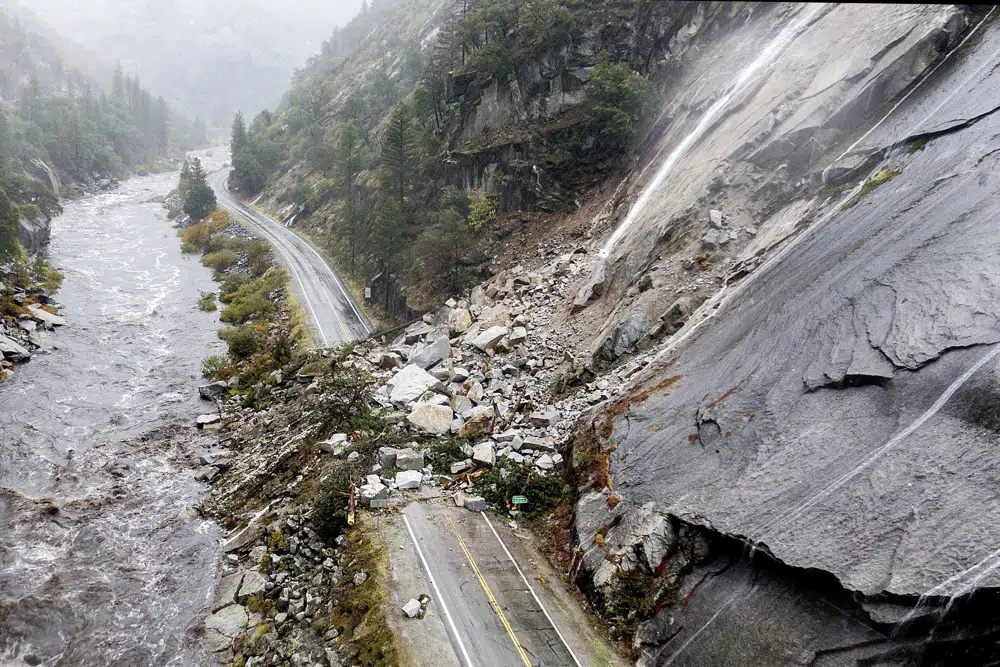 FILE - Rocks and vegetation cover Highway 70 following a landslide in the Dixie Fire zone on Oct. 24, 2021, in Plumas County, Calif. (AP Photo/Noah Berger, File)