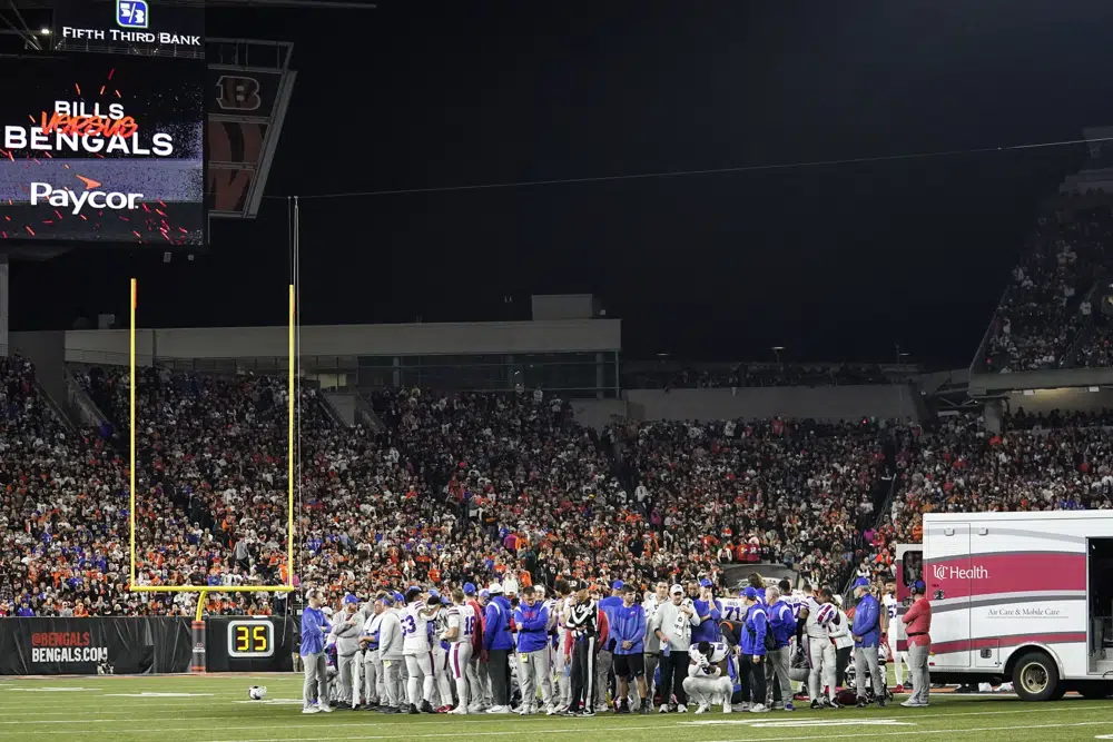 The Buffalo Bills players pray for teammate Damar Hamlin during the first half of an NFL football game against the Cincinnati Bengals, Monday, Jan. 2, 2023, in Cincinnati. The game has been postponed after Buffalo Bills' Damar Hamlin collapsed, NFL Commissioner Roger Goodell announced. (AP Photo/Joshua A. Bickel)