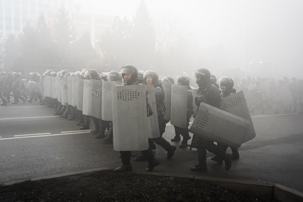 Riot police walk to block demonstrators during a protest in Almaty, Kazakhstan, Wednesday, Jan. 5, 2022. Demonstrators denouncing the doubling of prices for liquefied gas have clashed with police in Kazakhstan's largest city and held protests in about a dozen other cities in the country. (AP Photo/Vladimir Tretyakov)