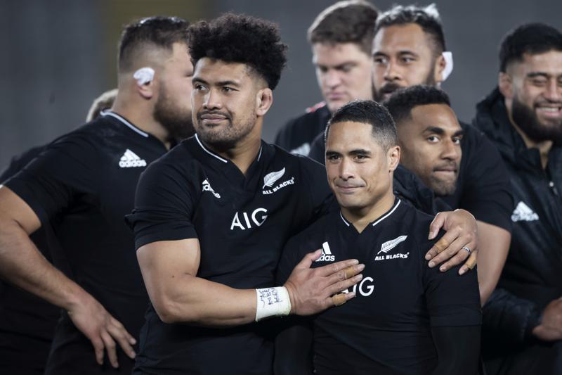 New Zealand's Ardie Savea, left, congratulates teammate New Zealand's Aaron Smith afterSmith's his 100th test after their Bledisloe Cup rugby union test match against Australia at Eden Park in Auckland, New Zealand, Saturday, Aug. 7, 2021. (Brett Phibbs/Photosport via AP)