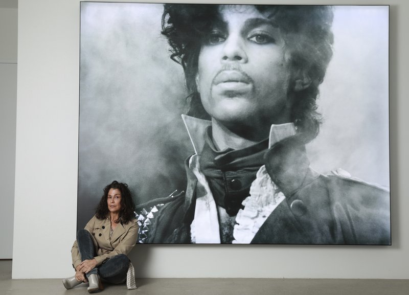 Susannah Melvoin poses next to a photo of Prince at Warner Music Group in Los Angeles on Friday, May 31, 2019. Melvoin, who recorded Prince's