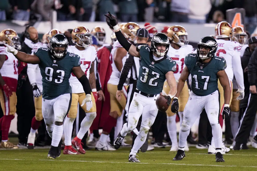 Jalen Hurts of the Philadelphia Eagles holds the George Halas