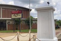 FILE - A pedestal that held a statue of Robert E. Lee stands empty outside a high school named for the Confederate general in Montgomery, Ala. on Tuesday, June 2, 2020. Two Montgomery high schools will no longer bear the names of Confederate leaders. The Montgomery County Board of Education has voted for new names for Jefferson Davis High School and Robert E Lee High School, news outlets report. (AP Photo/Kim Chandler, File)