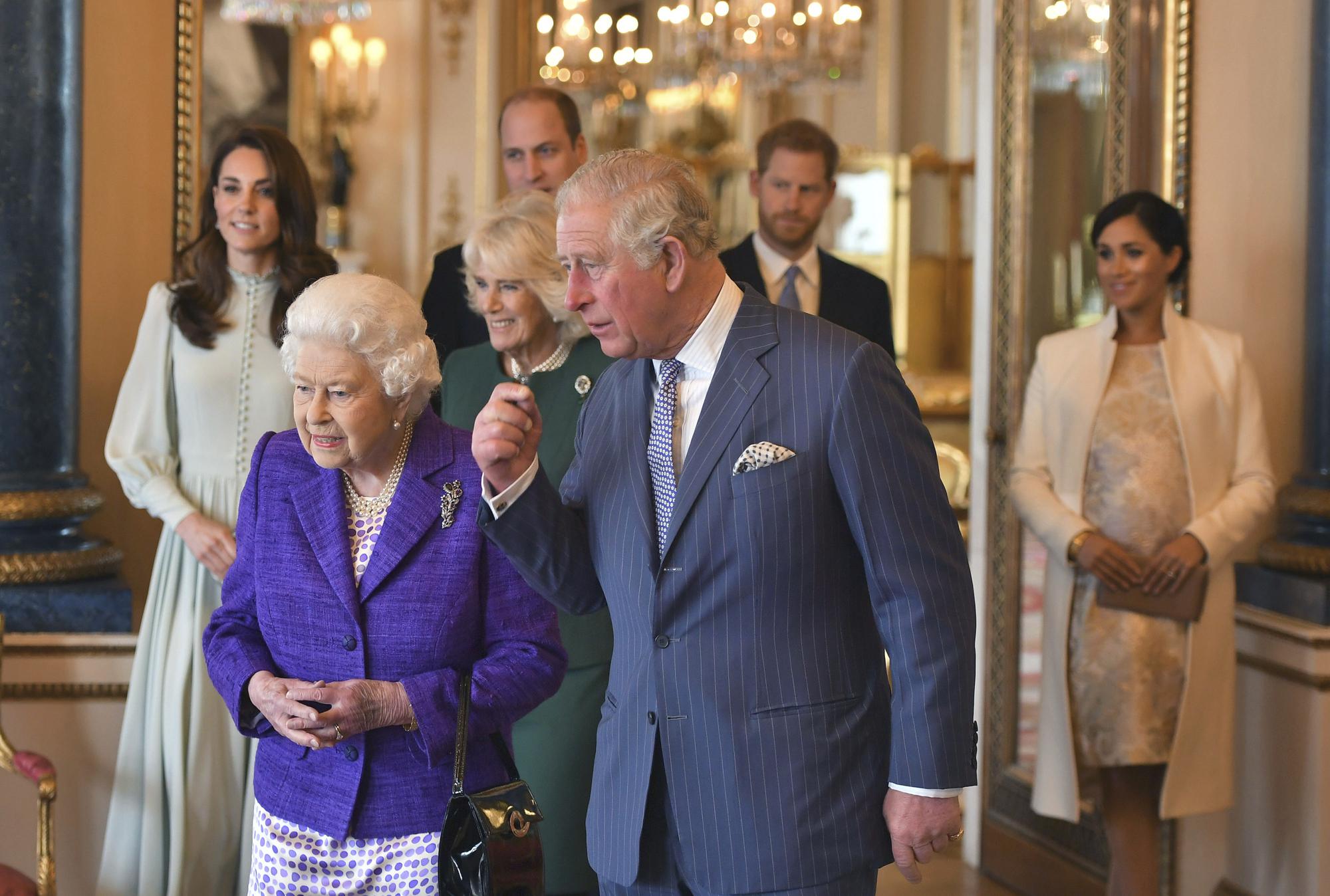 FILE - In this March 5, 2019 file photo, Britain's Queen Elizabeth II is joined by Prince Charles, the Prince of Wales, and at rear, from left, Kate, Duchess of Cambridge, Camilla, Duchess of Cornwall, Prince William, Prince Harry and Meghan, Duchess of Sussex during a reception at Buckingham Palace, London to mark the 50th anniversary of the investiture of the Prince of Wales. Prince Charles has been preparing for the crown his entire life. Now, that moment has finally arrived. Charles, the oldest person to ever assume the British throne, became king on Thursday Sept. 8, 2022, following the death of his mother, Queen Elizabeth II.  (Dominic Lipinski/Pool via AP, File)