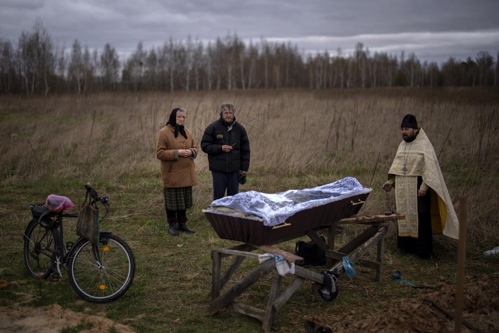 Nadiya Trubchaninova, 70, next to his soon Oleg Trubchaninov, 46, attends the funeral of her son Vadym, 48, who was killed by a Russian Army gunshot last March 30, during his funeral in Bucha, on the outskirts of Kyiv, Ukraine on Saturday, April 16, 2022. (AP Photo/Emilio Morenatti)