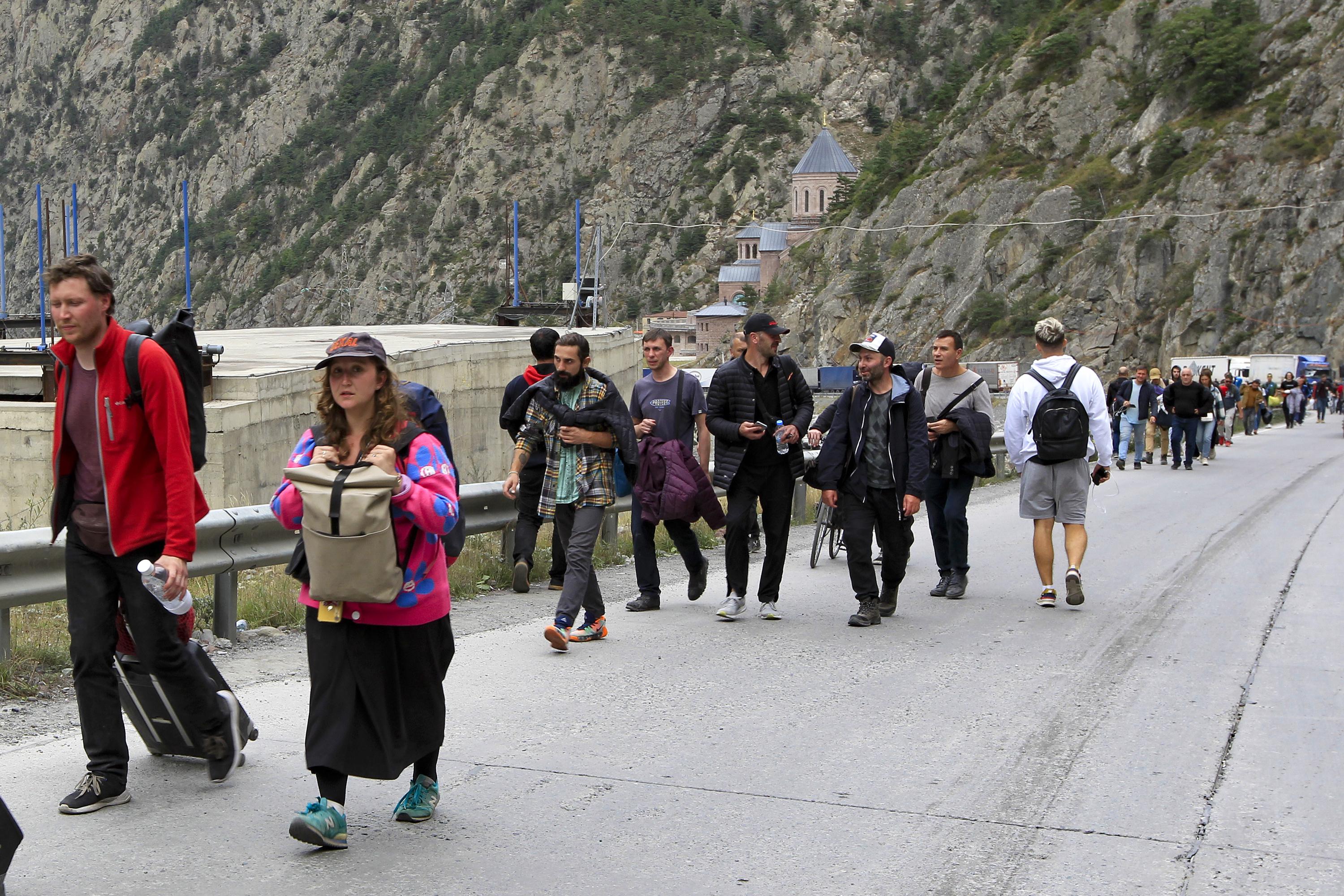 Moscow tries to draft fleeing Russian men at the borders AP News