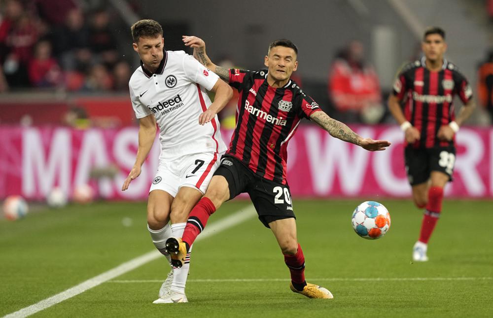 Frankfurt's Ajdin Hrustic, left, and Leverkusen's Charles Aranguiz challenge for the ball during the German Bundesliga soccer match between Bayer Leverkusen and Eintracht Frankfurt in Leverkusen, Germany, Monday, May 2, 2022. (AP Photo/Martin Meissner)