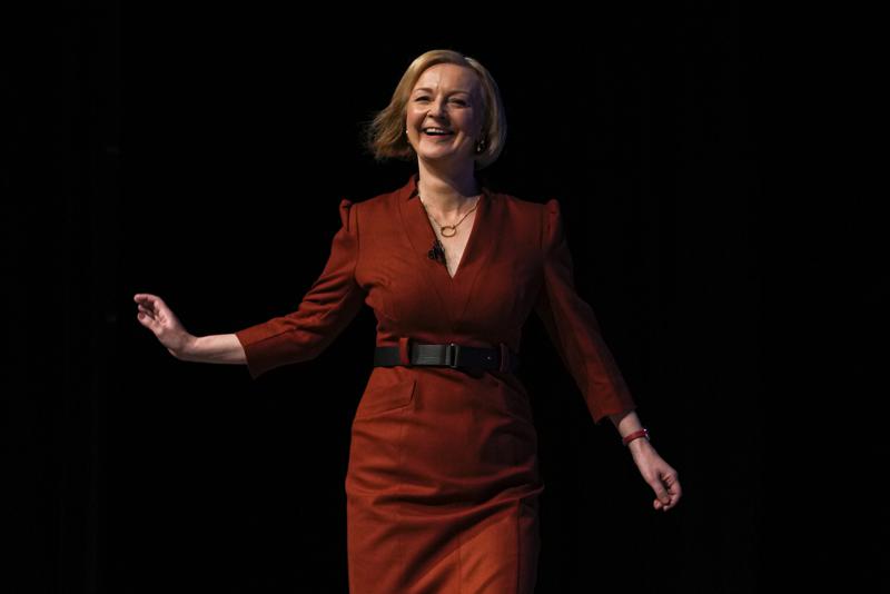 Britain's Prime Minister Liz Truss smiles before making a speech at the Conservative Party conference at the ICC in Birmingham, England, Wednesday, Oct. 5, 2022. (AP Photo/Kirsty Wigglesworth)