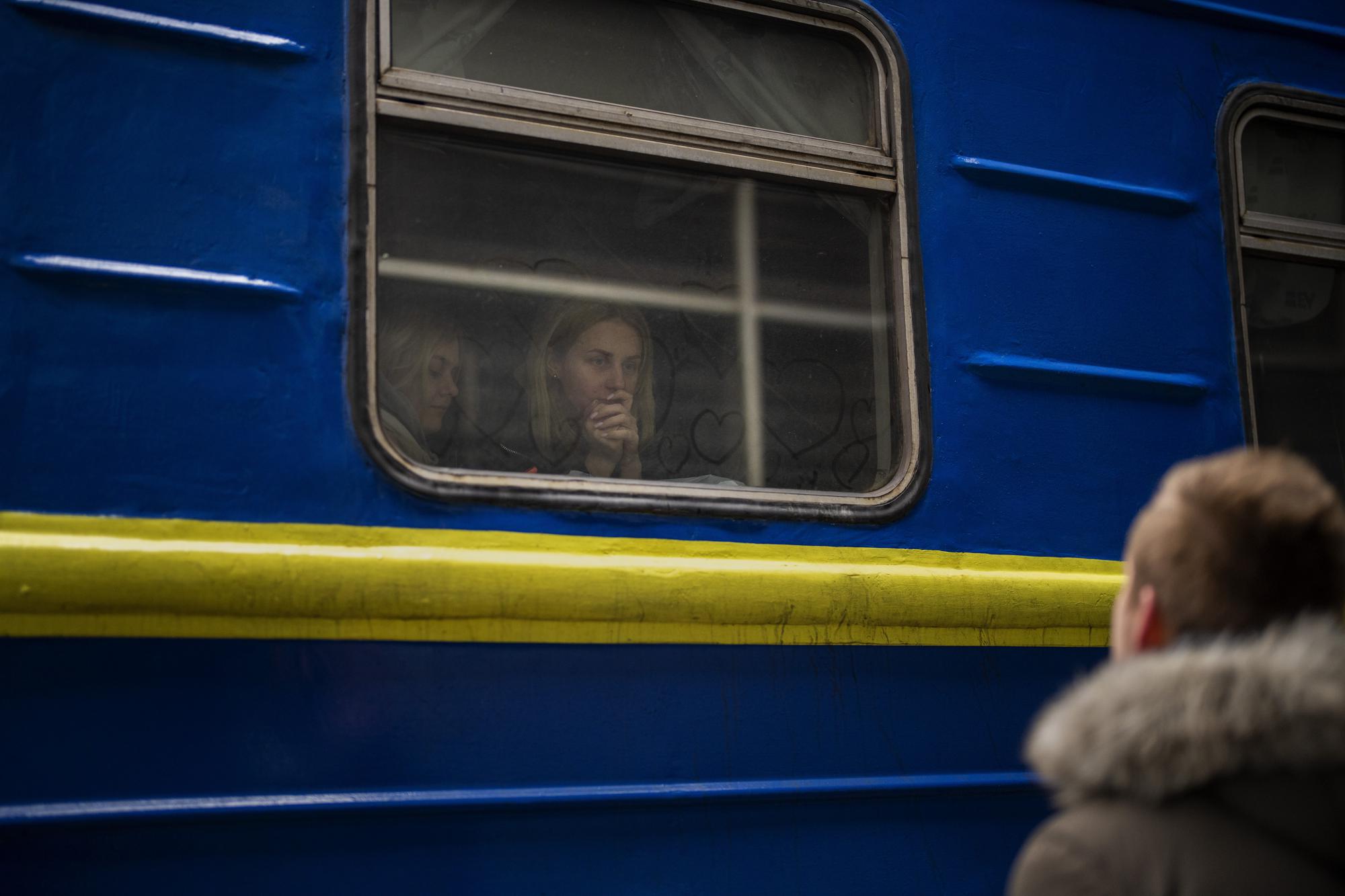 Bogdan, 41, says goodbye to his wife Lena, 35, on a train to Lviv at the Kyiv station, Ukraine, Thursday, March 3. 2022. Bogdan is staying to fight while his family is leaving the country to seek refuge in a neighboring country. (AP Photo/Emilio Morenatti)